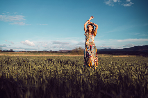 Beautiful young woman posing in wheat field.