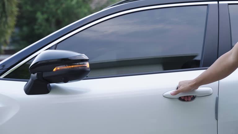 Man unlock white modern car with fingerprint scanning on handle