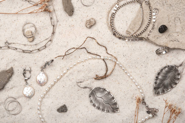 istock Beautiful Silver and Pearl Jewelry on white sand. 1483507654