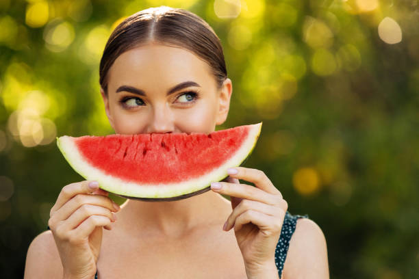 istock Beautiful girl enjoying watermelon 1483508457