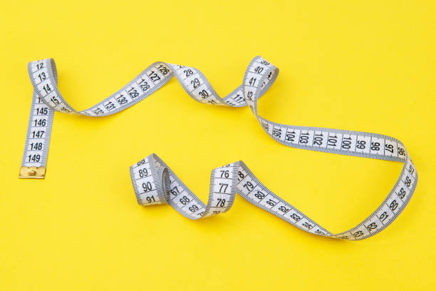 istock white tape measuring isolated on a yellow background 1483509245
