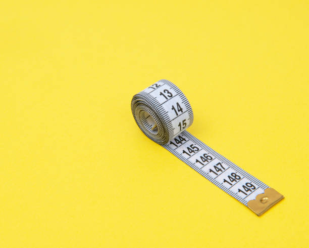istock white tape measuring isolated on a yellow background 1483509371