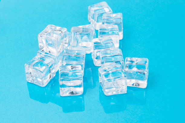 istock Ice cubes on blue background, Cubes of ice on a light blue background, Flat lay, top view 1483513255