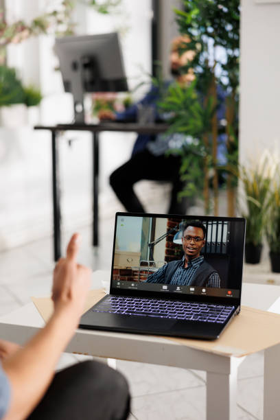 istock Executive on laptop screen listening to presentation through videocall 1483516739