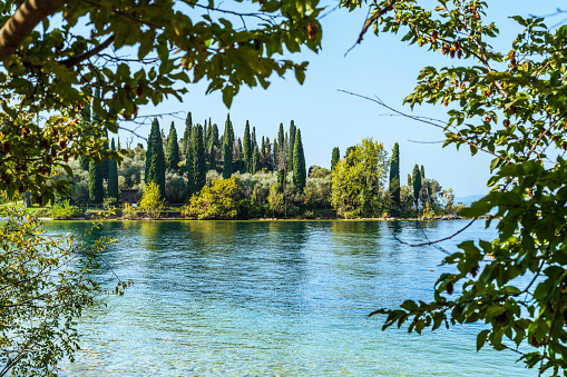 Lake Garda, eastern side. Punta San Vigilio. The still waters of the lake during the last days of summer.