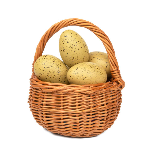 Easter eggs in the woven basket isolated on white background with clipping path.