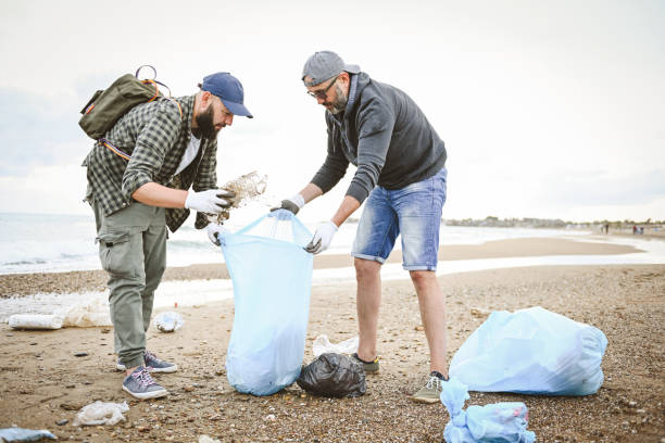 istock friends clean up trash on the beach 1483517368