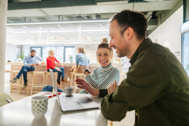 Colleagues taking a coffee break in the office cafeteria