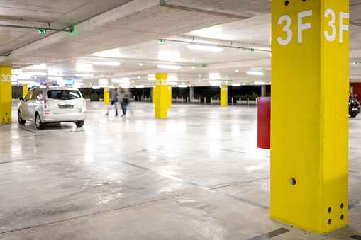 Car parking in underground parking space at night.