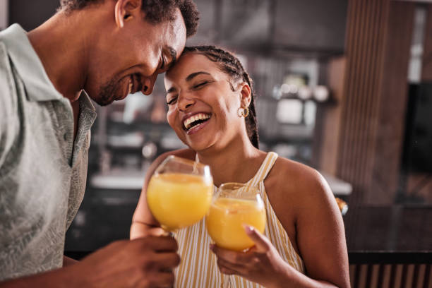 istock Cheerful black couple toasting with juices at home. 1483519783