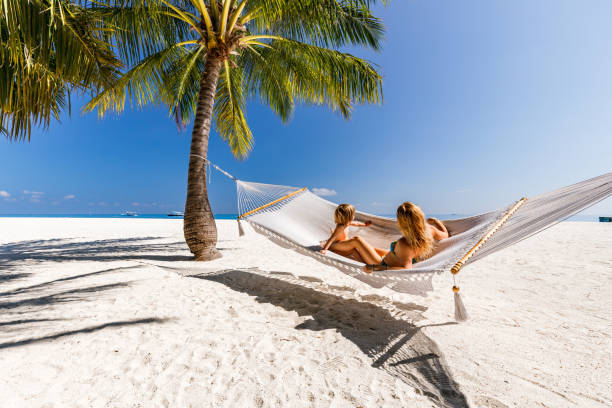 istock Small boy and his single mother having fun in hammock on the beach. 1483521286