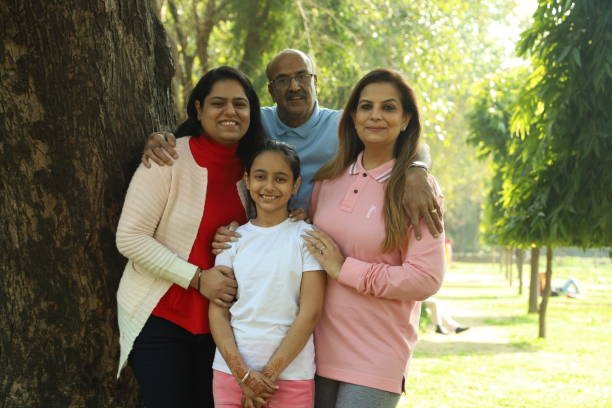 istock Family in the park standing beside a tree. 1483521457