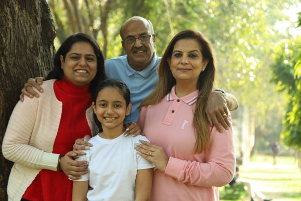 istock Family in the park standing beside a tree. 1483521463