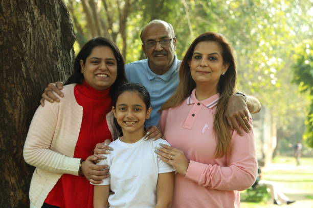 istock Family in the park standing beside a tree. 1483521464