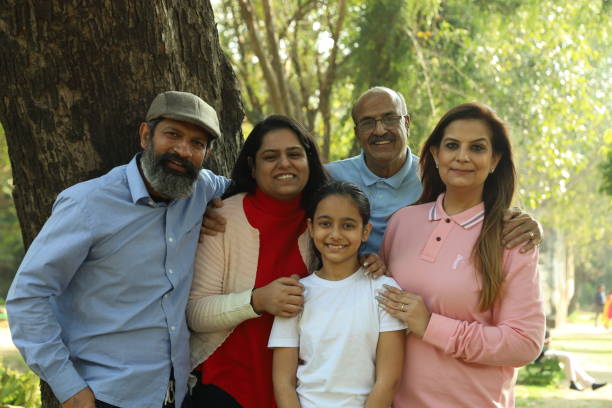 istock Family in the park standing beside a tree. 1483521476