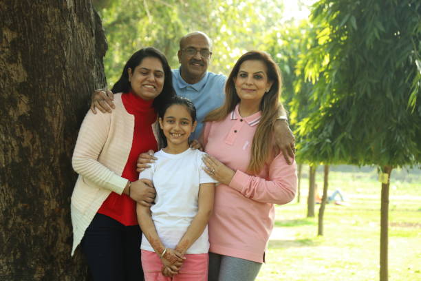istock Family in the park standing beside a tree. 1483521477