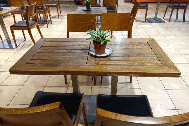 istock Wooden table with chairs with backs in a cafe. 1483521940