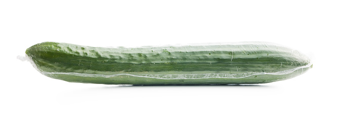 Fresh green cucumber wrapped in plastic wrap isolated on the white background.