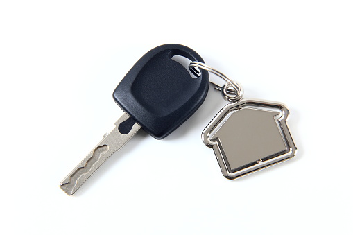 Car key and house model isolated on white background