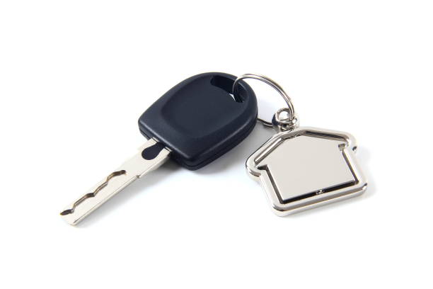 istock Car key and house model isolated on white background 1483525511