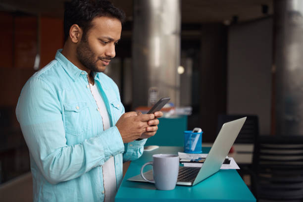 istock Young man writing message to client in the office 1483526637