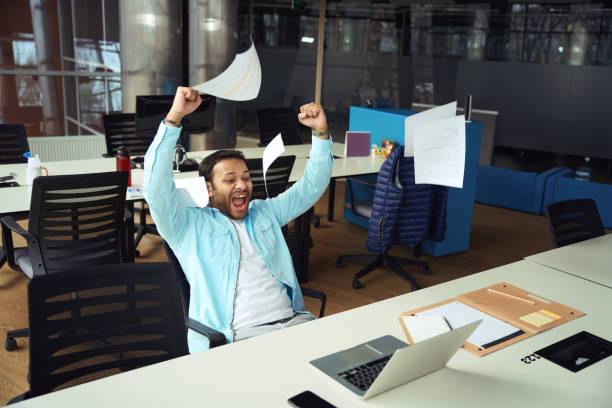 istock Young male looking into laptop and rejoices 1483526763
