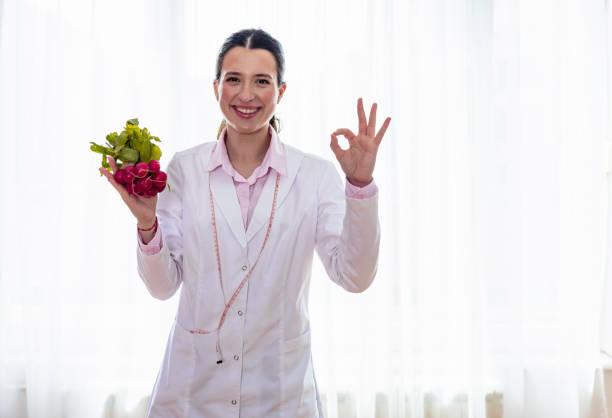 Young female nutritionist holding fresh radishes