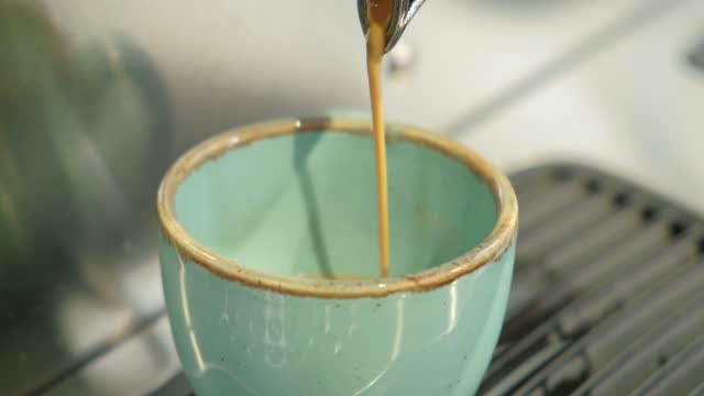 Close up video of barista making espresso in cafe.