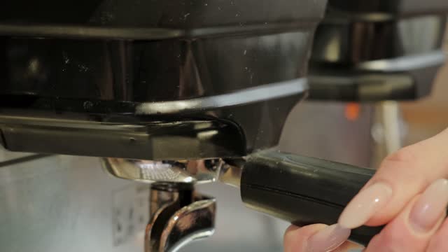Close up video of barista making espresso in cafe.