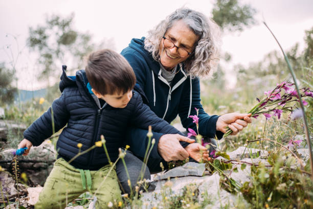 istock grandma and granddaughter picking flowers 1483529529