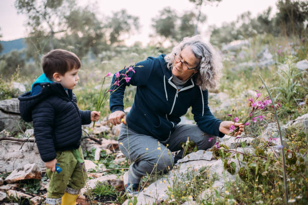 istock grandma and granddaughter picking flowers 1483529566