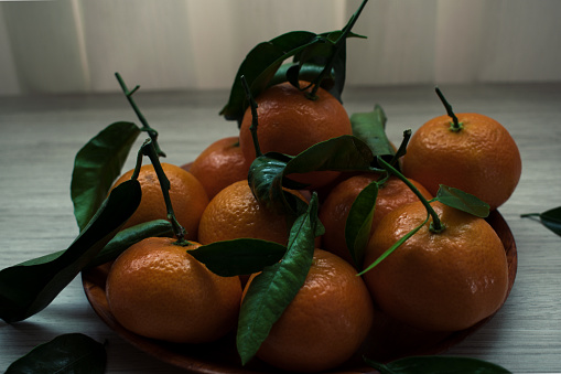 Fresh-picked organic tangerines in a fruit bowl