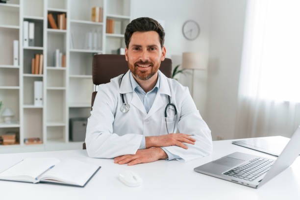 istock Sitting by a table. Doctor in formal clothes is working in the cabinet 1483531273