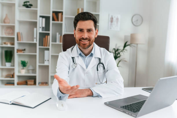 istock Sitting by a table. Doctor in formal clothes is working in the cabinet 1483531292