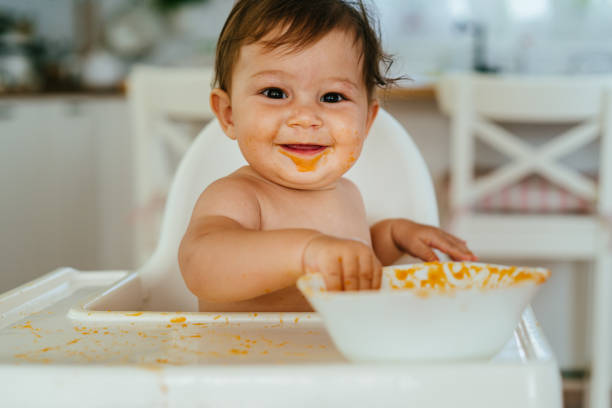 istock Messy Baby Girl Eating By Her Self 1483533247