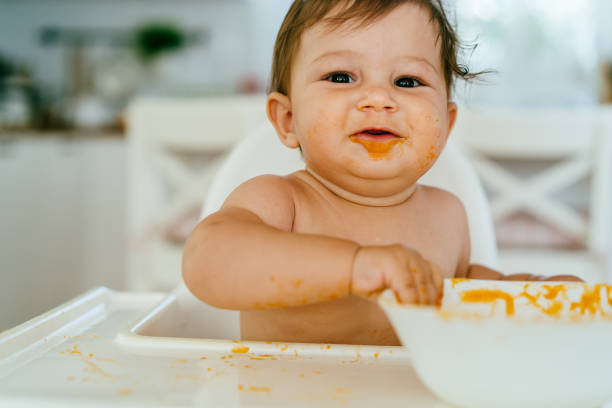 istock Messy Baby Girl Eating By Her Self 1483533301