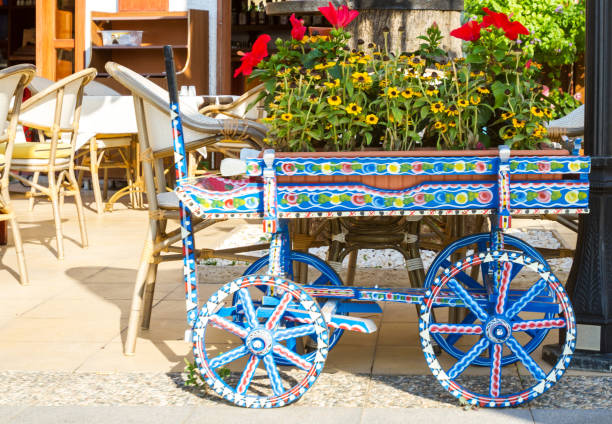 Decorative cart with flowers in a cafe in the garden.