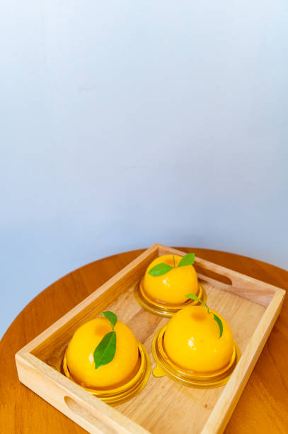 istock Round orange cake in a tray on a wooden table 1483535646