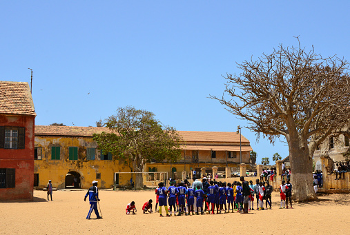Gorée Island, Dakar, Senegal: players before a soccer match  - colonial buildings and baobab tree - Government Square / Palace Square.
