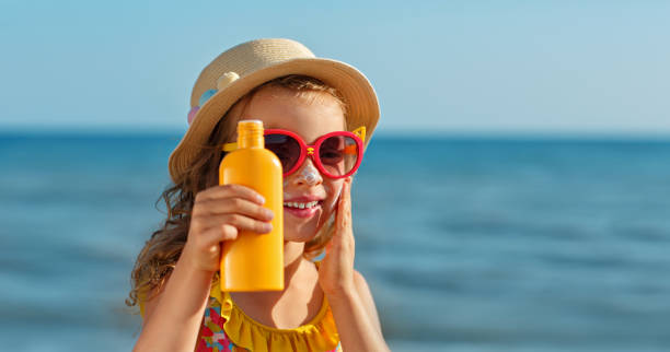istock The child holds a bottle of moisturizing Sunscreen in his hands and puts a protective layer on his face. 1483538874
