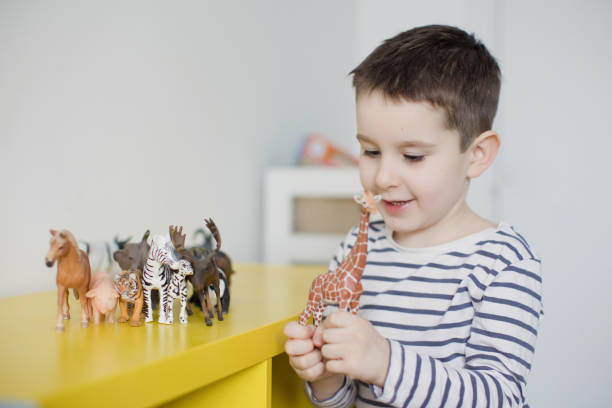 istock Child playing with animal figurines toys 1483540230