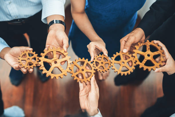istock Office worker holding cog wheel as unity and teamwork in workplace. Concord 1483540446
