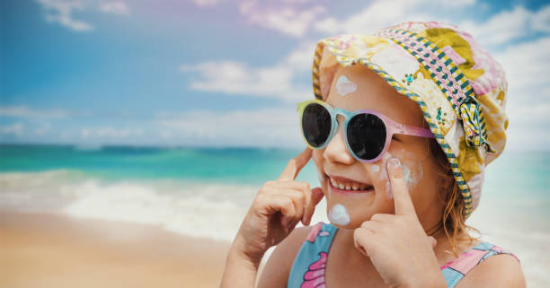 istock child put on sunscreen on face at beach. skin protection from sunburn. banner with copy space 1483540951