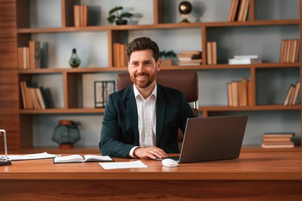 istock Using laptop. Businessman in formal clothes is working indoors 1483542597