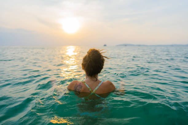istock Woman swimming at sunset 1483542693
