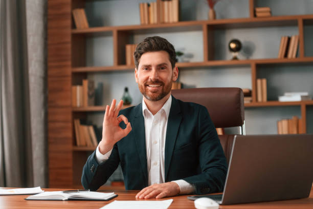 istock Front view. Businessman in formal clothes is working indoors 1483542710