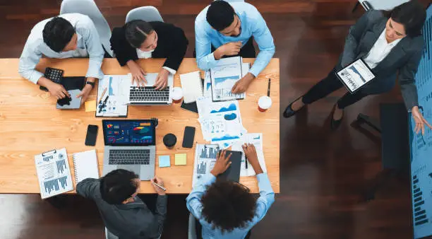 Top view business presentation with data analysis dashboard on TV screen in modern meeting room. Business people brainstorming or working together to plan business marketing strategy. Concord