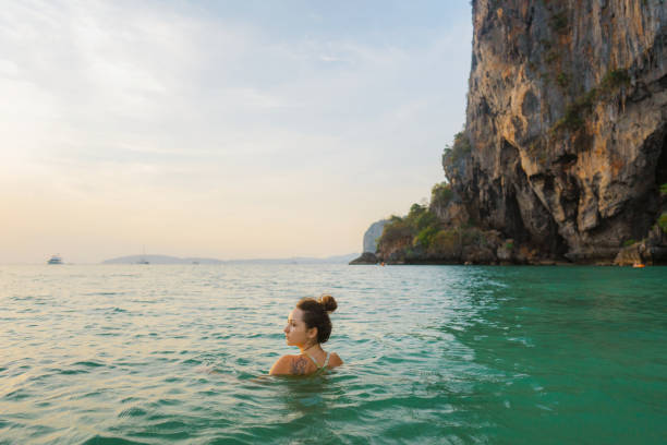 istock Woman swimming at sunset 1483543052