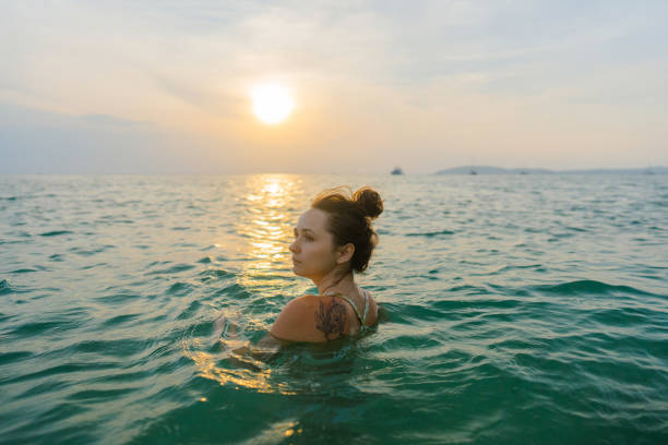 istock Woman swimming at sunset 1483543054