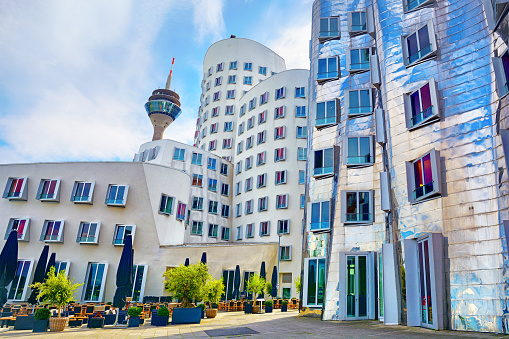 The Rheinturm tower and Neuer Zollhof (Der Neue Zollhof) building complex, Germany. This buildings was designed by American architect Frank O. Gehry and completed in 1998